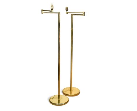 A brass floor standing articulated reading lamp by Hansen, USA, circa 1970, with weighted circular base and adjustable height