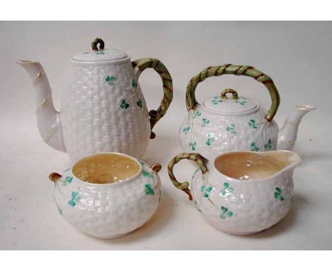 A Belleek porcelain four-piece tea service, of basket weave form with organic handles, shamrock decorated, comprising teapot,