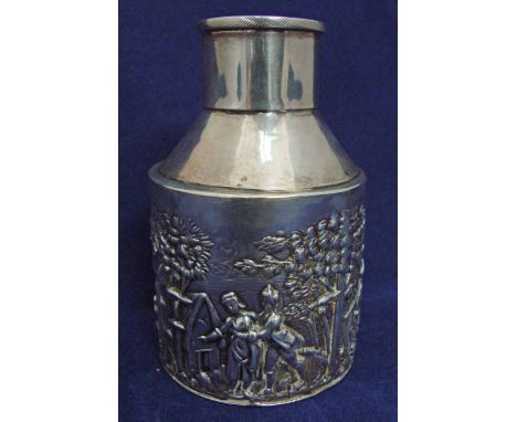 An Edwardian silver tea caddy of small proportions, circular form with tapered shoulder and central cover, repoussé decorated