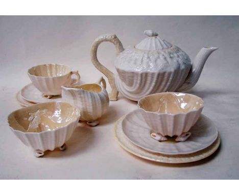 A Belleek porcelain nine-piece tea service for two, of shell form with yellow lustre colouration, comprising teapot, sucrier,