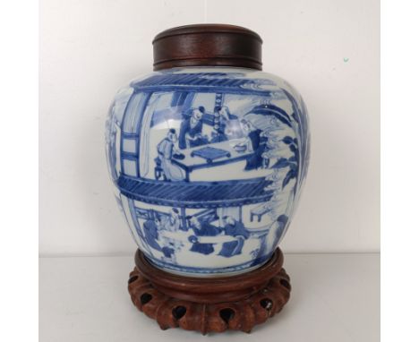 A Chinese blue and white ginger jar, with a carved wooden cover, on a carved wooden stand, 31 cm high overallTwo or three chi