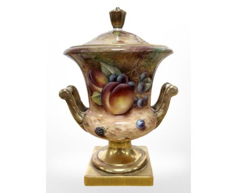 A Royal Worcester campana-shape lidded twin-handled urn, hand painted with fruit, black painted mark, numbered 4128, signed T