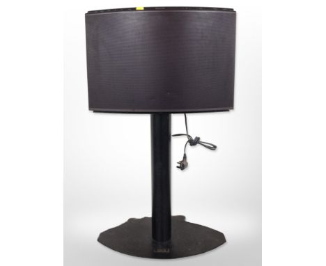 A Bang & Olufsen Beosound 1 curved speaker on speaker stand, with lead.
