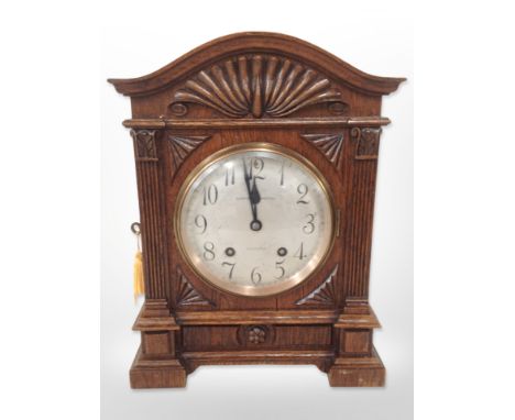 A carved oak eight day bracket clock, with silvered dial signed Curtis and Horspool, Leicester, height 37cm, striking on a go