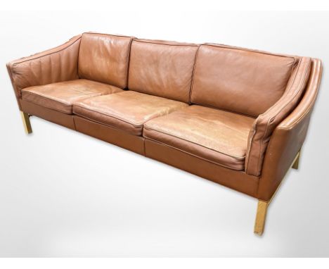 A late 20th-century Danish terracotta leather three-seater settee, length 220cm x depth 80cm x 70cm. CONDITION REPORT: Overal