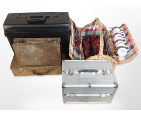 Two brown leather luggage cases, wicker picnic hamper, aluminium multi compartment chest and a further luggage case 