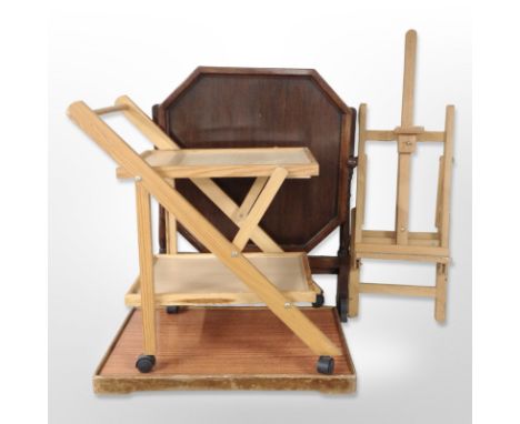 An oak octagonal folding table, folding easel, trolley and a serving tray 