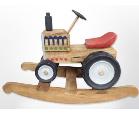 A child's painted wooden rocking tractor seat 