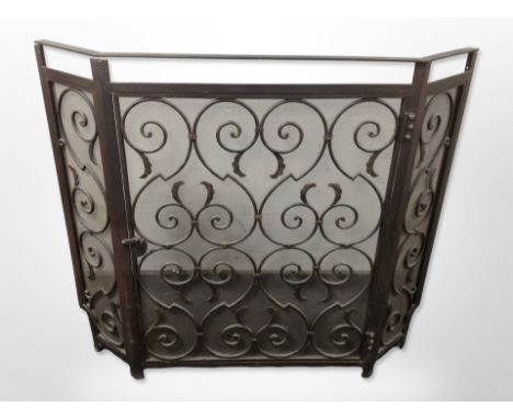 A metal fire screen with hinged central door, width 103cm.