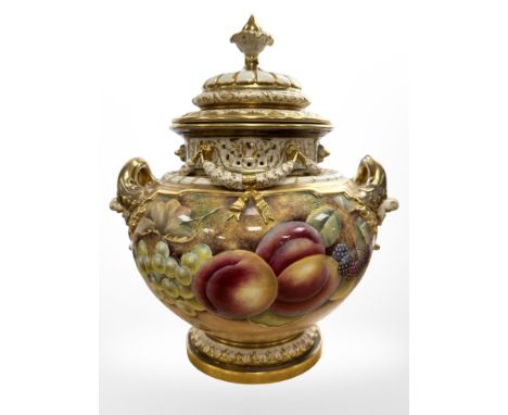 A Royal Worcester twin handled pot pourri vase and cover, shape 1428, hand painted with an arrangement of fruit beneath a pie