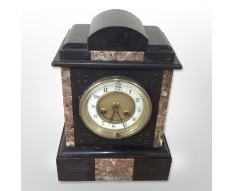 A Victorian black slate and rouge marble mantle clock, height 27cm, striking on a bell with pendulum.