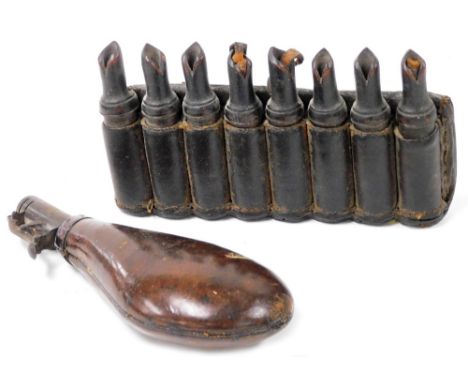 A 19thC leather and wooden section gun powder holder, 20cm wide, together with a leather bound metal shot flask, 21cm wide. (