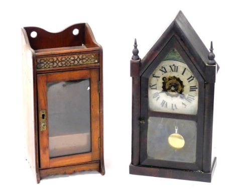 A late 19thC American stained pine mantel clock, of Gothic form the painted enamel dial bearing Roman numerals, movement with