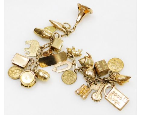 An oval link identity charm bracelet, yellow metal with twenty four charms as fitted, on a bolt ring clasp, most charms and b