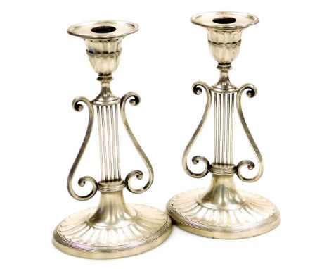 A pair of Victorian silver Neo-Classical candlesticks, of lyre form raised on an oval fluted base, 20.5cm high, Harrison Brot