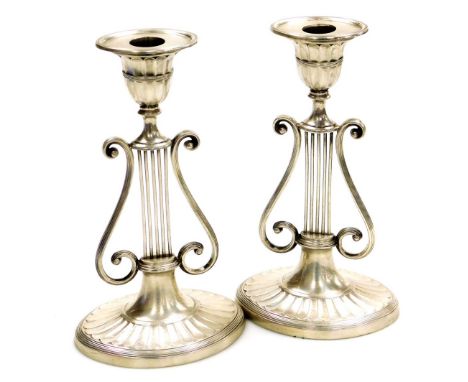 A pair of Victorian silver Neo-Classical candlesticks, of lyre form raised on an oval fluted base, 20.5cm high, Harrison Brot