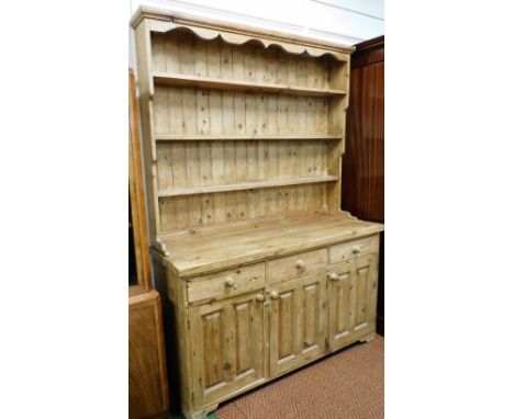 A Victorian style pine kitchen dresser, with a three shelf plate rack, above three drawers over three panelled cupboard doors