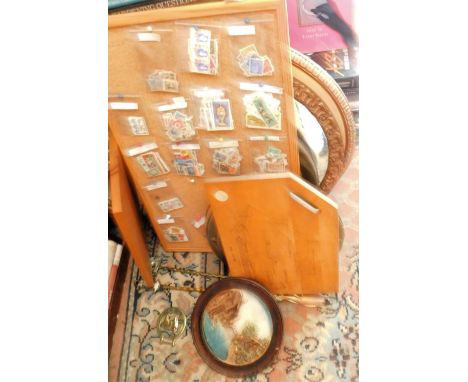 An oval gilt mirror, convex wall mirror, pokerwork panels, loose stamps, brass tasting fork, horse brasses.   This lot is sit