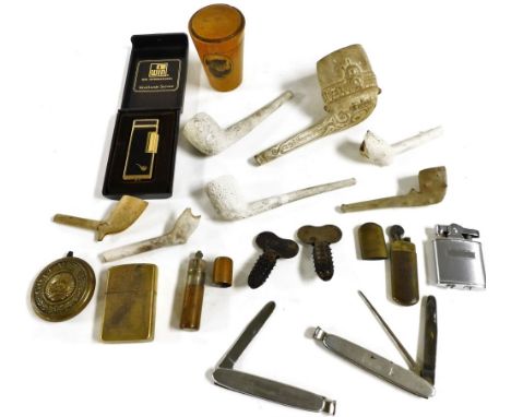 A Victorian clay pipe, moulded with the Crystal Palace and dated 1867, further clay pipes, pocket lighters, Hedgehog pipe rea