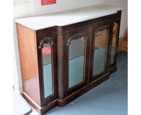 A Victorian walnut and marble topped breakfront sideboard, the mirrored front having two doors opening to reveal a single she