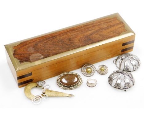 Silver and costume jewellery, including brooches, belt buckles and a silver ring, contained in a brass bound wooden box. 