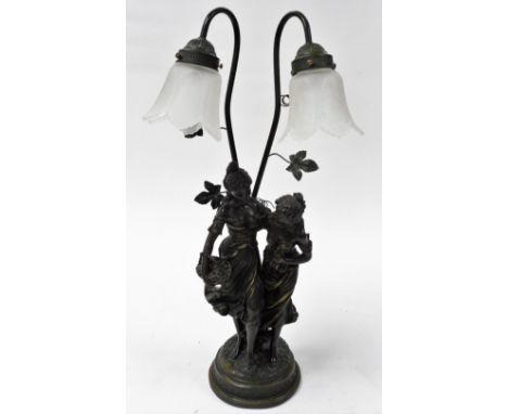 A bronze patinated plaster figural table lamp, modelled as two standing female figures, two branch screw in arms with frosted