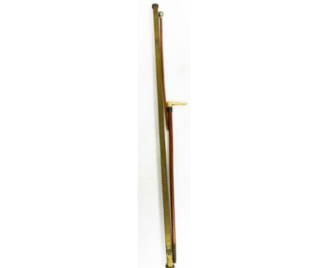 A Thompson Brothers Billesdon brass measuring stick, 136cm long, a West Indian Assaye swagger stick, and a Swaine and Co Lond