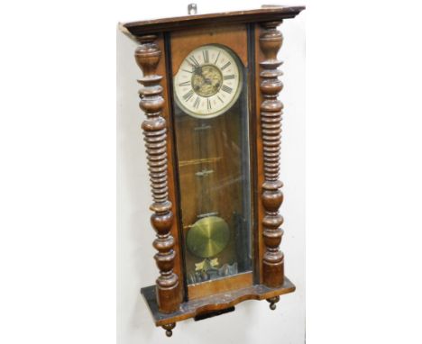 A late 19thC Continental walnut cased wall clock, circular brass dial with chapter ring bearing Roman numerals, eight day mov