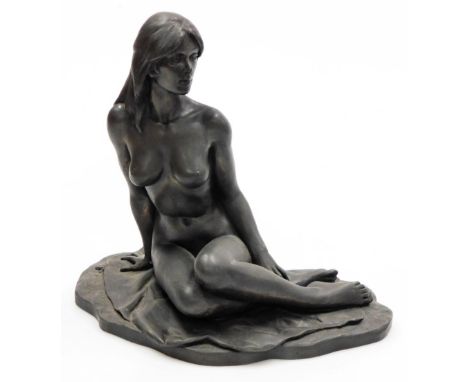 Roland Chadwick. A bronze finished resin figure of a naked lady, model seated on a sheet, 29.5cm wide.