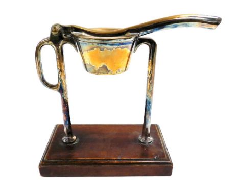 A late 19thC Mappin and Webb silver plated bar top lemon squeezer, RD number 88602, raised on a rectangular wooden base, impr