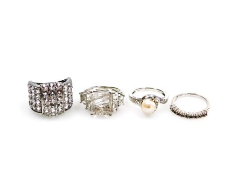 Four silver dress rings, comprising a cultured pearl and cz set twist ring, half hoop eternity ring, and two cluster rings, b