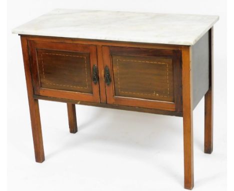 An Edwardian mahogany and inlaid marble top wash stand, tile splash back lacking, with a pair of cupboard doors, raised on sq