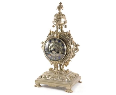 A 19thC silvered bronze mantel clock, in highly elaborate case surrounded by a compressed finial with flower head, raised abo
