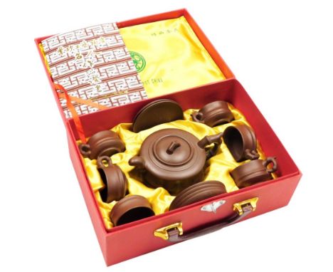 A modern Yixing purple clay tea set, comprising teapot, six cups and six saucers, in presentation box with certificate. 