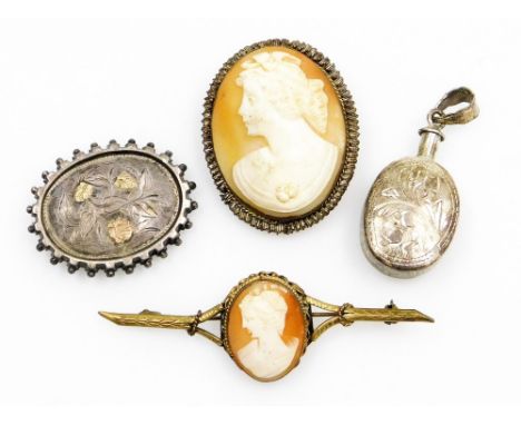 A silver oval pendant, with engraved foliate decoration, Victorian silver bicolour brooch engraved with flowers, a cameo broo