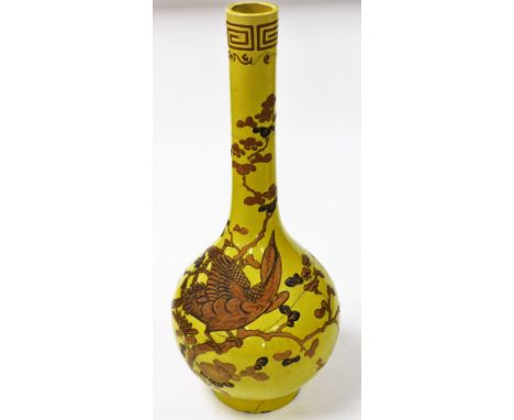 A 19thC Chinese yellow ground bottle vase, decorated in gilt and enamels, with a phoenix perched amongst prunus blossom, bene