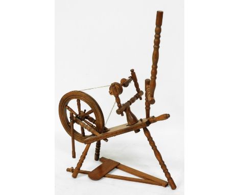 A light oak spinning wheel, 73cm wide. 