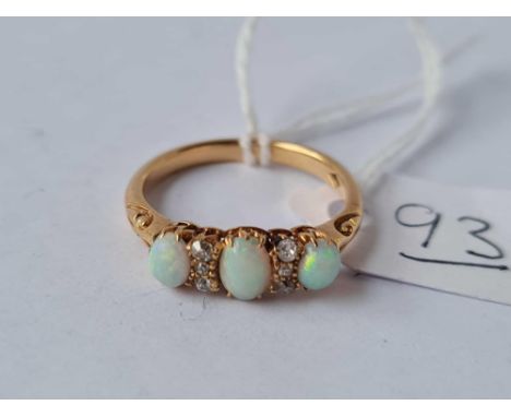 A gold three stone opal ring with diamond points size K 3.1g inc