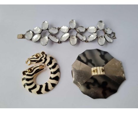 A compact, bracelet, brooch 