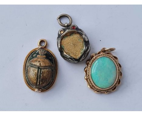 A opal and scarab pendants set in gold and a silver example 