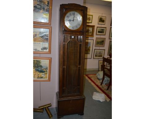 An early 20th Century oak cased grandfather clock, the silvered arabic dial above glazed central panel.