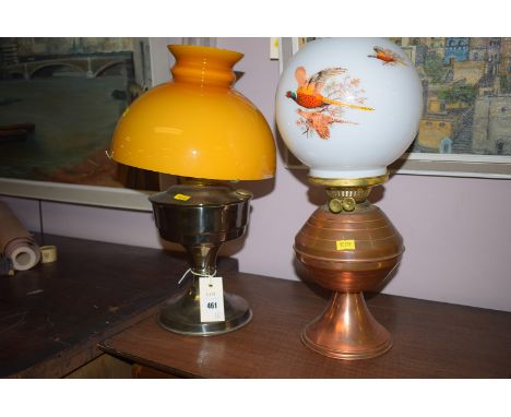 A copper oil lamp with opaque white glass shade and pheasant decoration; and another oil lamp with orange shade.  (2)
