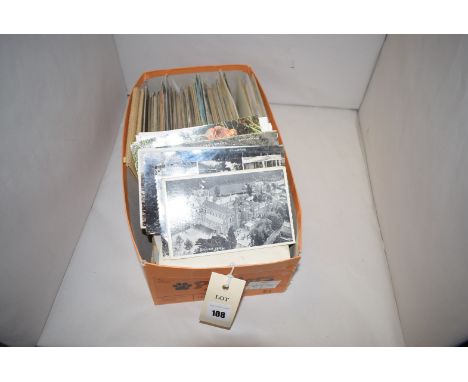 A box of vintage postcards.
