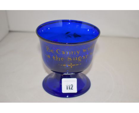 A Newcastle blue glass sugar bowl with lettering 'Be canny with the sugar".