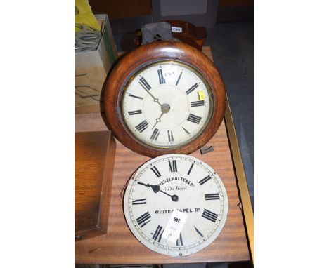 An Edwardian inlaid mahogany mantel clock; a Victorian wall clock in mahogany frame with enamel clock face.