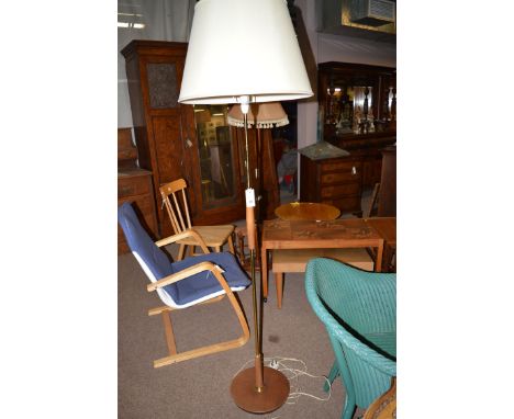 A stained wood and brass standard lamp with cream coloured shade.