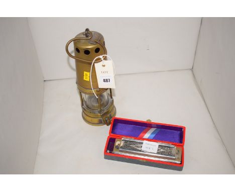 A brass miner's safety lamp J Mills & Co. Newcastle with brass thimble top with four brass bars and a hasp lock; and a Hohner