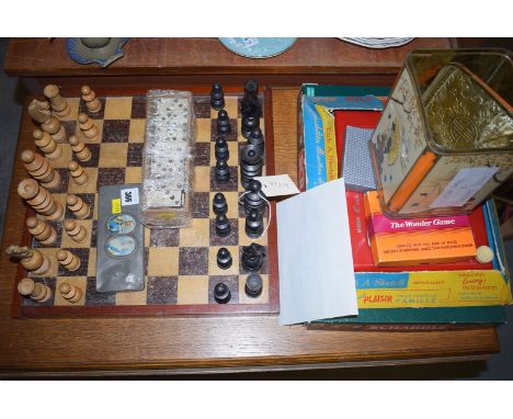 A wooden chess set and board; two sets of dominoes; an Etch-a-Sketch in original box; a Scrabble game; card games; etc.