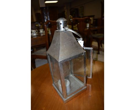 A hanging candle lantern in brushed steel.