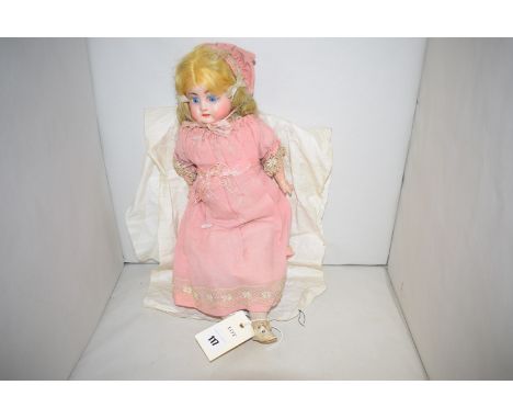 A vintage doll with composite head.